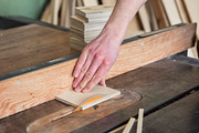 Construction worker cutting wooden