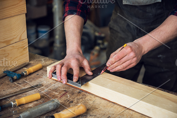 The worker makes measurements of a