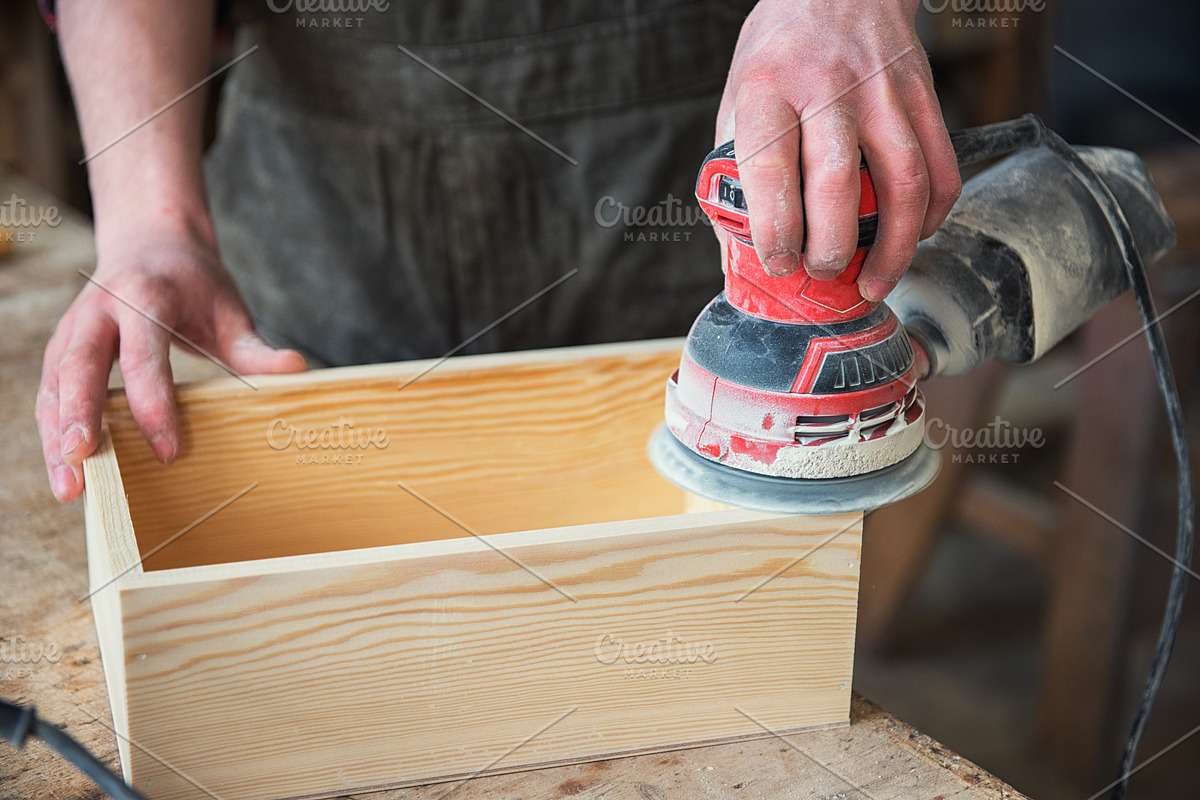 Worker grinds the wood box in Graphics - product preview 8