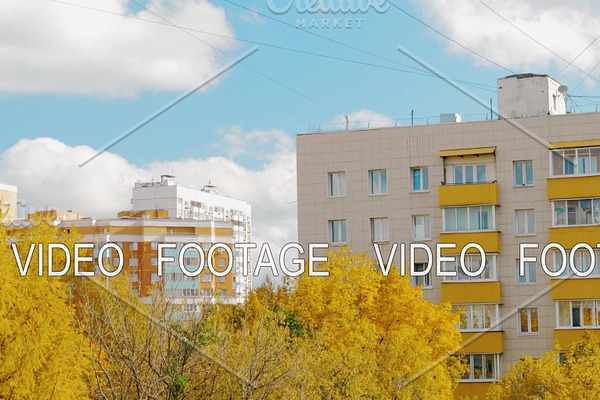 Apartment houses and yellow trees in