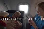 Baby in a cot on an airplane