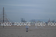 Young boy walking on the beach on a