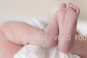 Newborn baby girl with her feet in