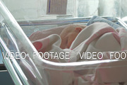 A newborn baby girl lying awake in a