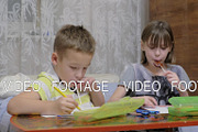 Children drawing pictures and eating
