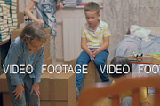 Group of kids playing among boxes at