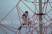 A boy on a red climbing web