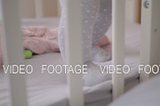 Cute baby girl in a round crib 2