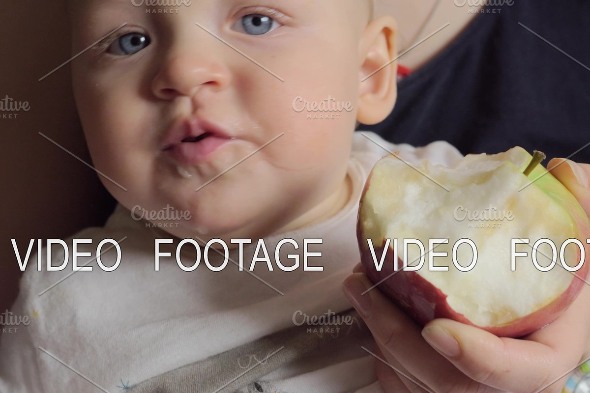 One year old baby eating apple in Graphics - product preview 8