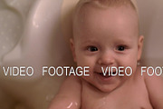 Happy baby girl bathing