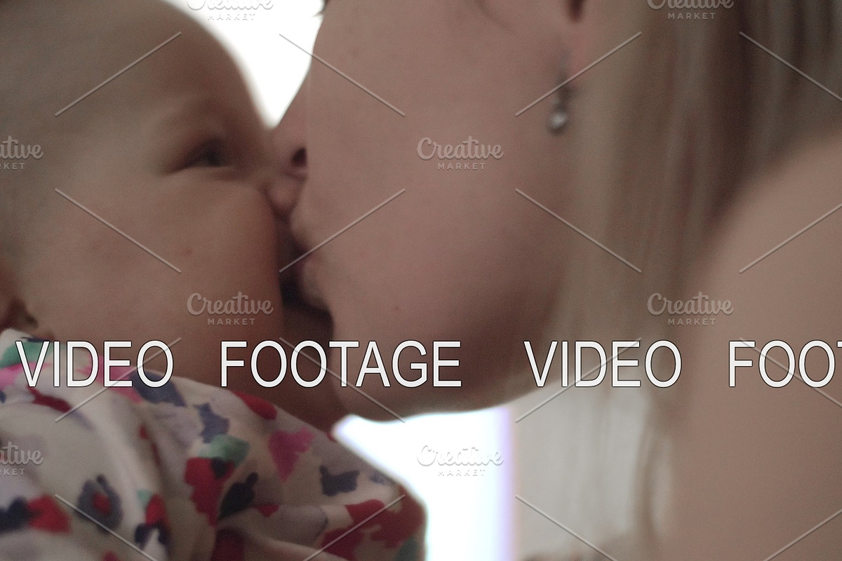 Baby being held and kissed by her in Graphics - product preview 8