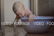 Cute baby girl in a round blue tub 3