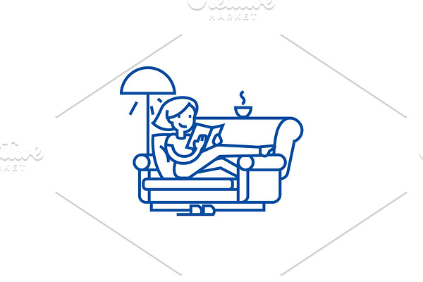 Woman at home at sofa reading book
