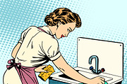 woman cleans kitchen sink