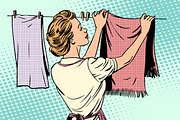 woman hangs clothes after washing