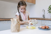 little girl learns to cook in the