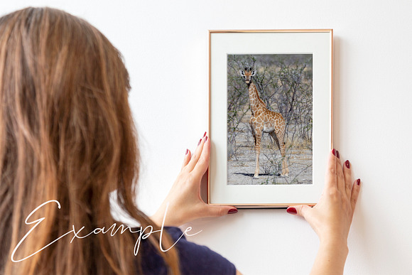 Woman holding frame on wall Mockup in Product Mockups - product preview 2