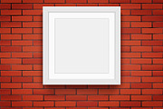 Red brick wall with picture frames