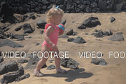 Little girl walking at the beach