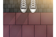 Feet in sneakers on cobblestone
