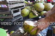 Man chopping a fresh coconut.