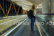 Woman on escalator at international