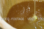 Honey dripping in a bucket.
