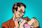 Happy father feeding newborn baby