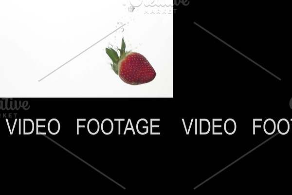 A slow motion of a strawberry being