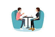 Two young woman chatting in a coffee