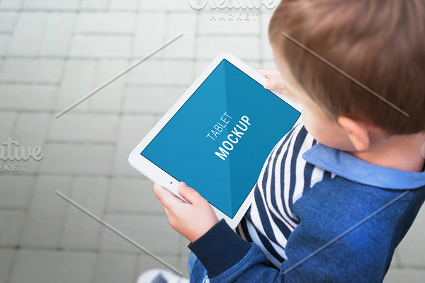Boy with tablet mockup on street