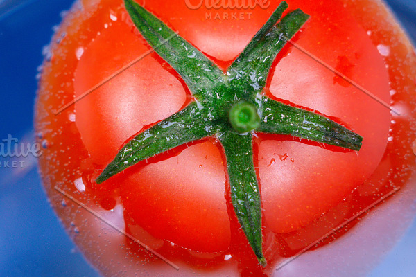 red ripe tomato close-up in water