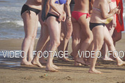 Women in swimsuits on the beach