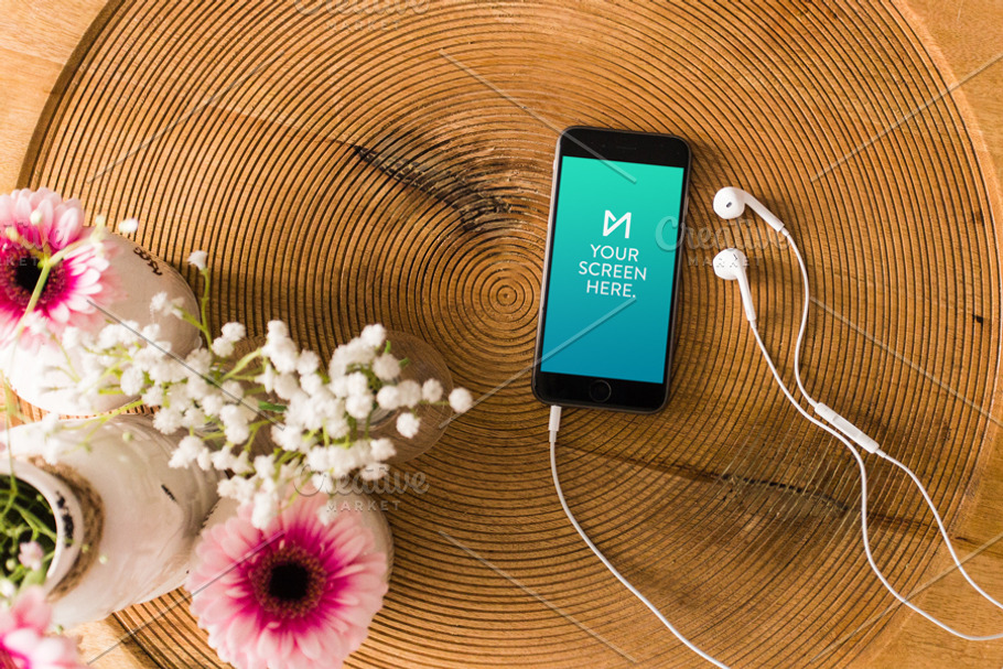 iPhone 6 on table with earbuds in Mobile & Web Mockups - product preview 8