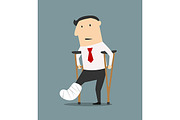 Businessman with broken leg and crut
